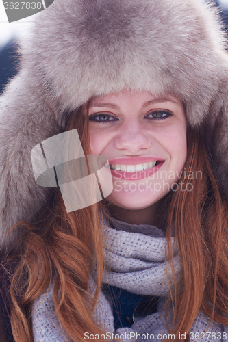 Image of portrait of beautiful young redhair woman in snow scenery