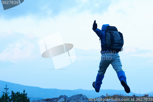 Image of advanture man with backpack hiking