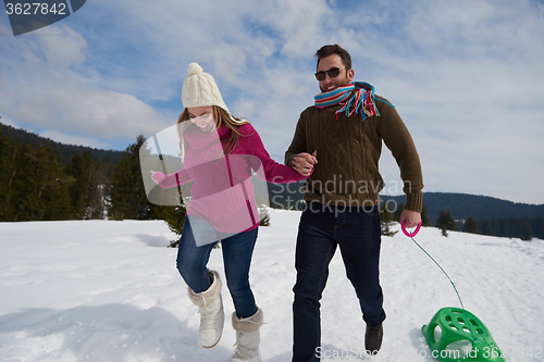 Image of happy young couple having fun on fresh show on winter vacation