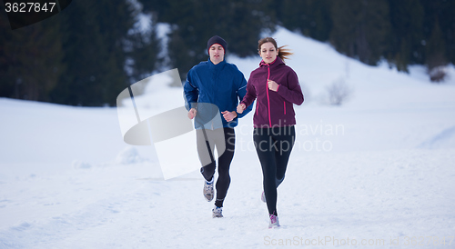 Image of couple jogging outside on snow