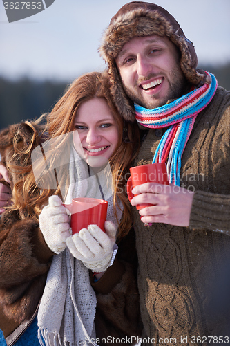 Image of couple drink warm tea at winter