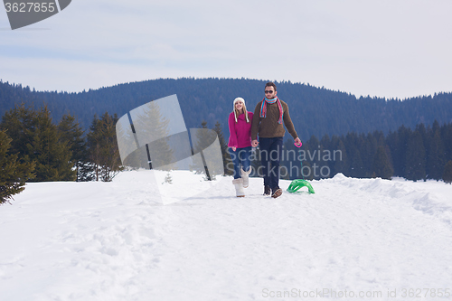 Image of happy young couple having fun on fresh show on winter vacation