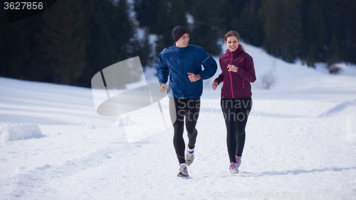 Image of couple jogging outside on snow