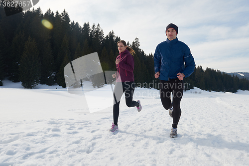 Image of couple jogging outside on snow