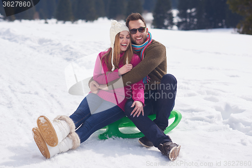 Image of happy young couple having fun on fresh show on winter vacation