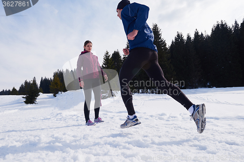 Image of couple jogging outside on snow