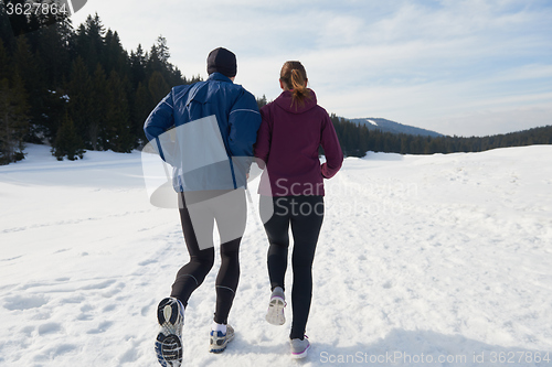 Image of couple jogging outside on snow