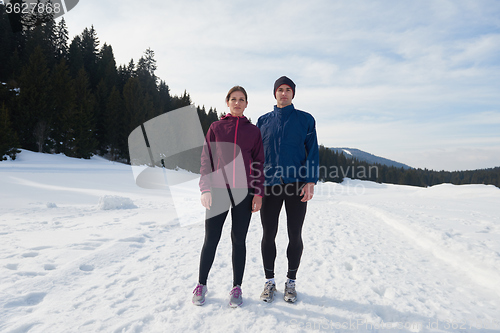 Image of couple jogging outside on snow