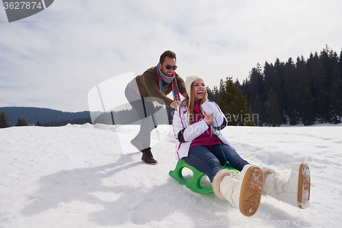 Image of happy young couple having fun on fresh show on winter vacation