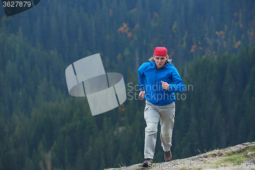 Image of advanture man with backpack hiking