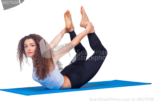 Image of Studio shot of a young fit woman doing yoga exercises.