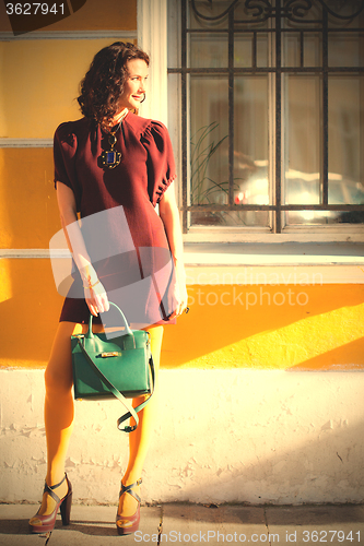Image of beautiful woman in a burgundy dress