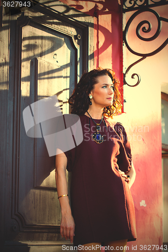 Image of beautiful middle-aged woman near the ancient door