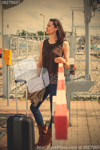 Image of woman with luggage is waiting for permission to pass through the