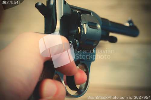 Image of revolver in a human hand