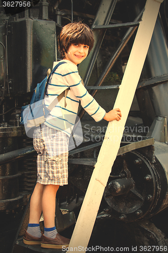 Image of child-researcher on the stairs of an old steam locomotive