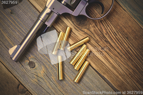 Image of Vintage revolver Nagant and the seven golden cartridges