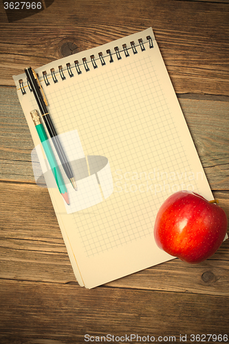 Image of still life with notebook and apple