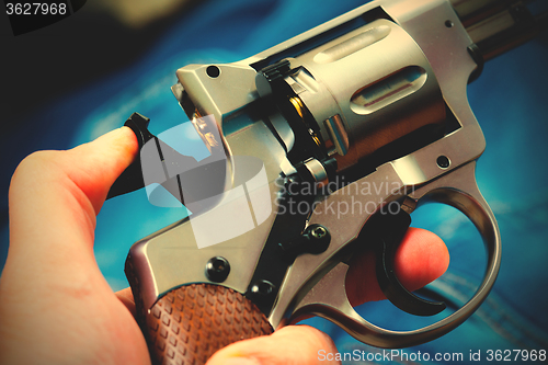 Image of revolver in human hand