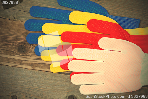 Image of four colored construction gloves