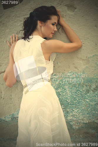 Image of beautiful middle-aged woman in a white dress