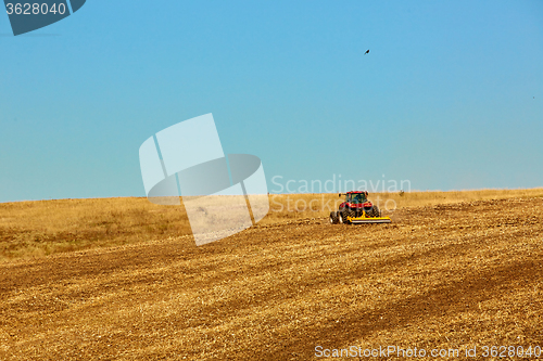 Image of Agricultural Landscape. Tractor working on the field.