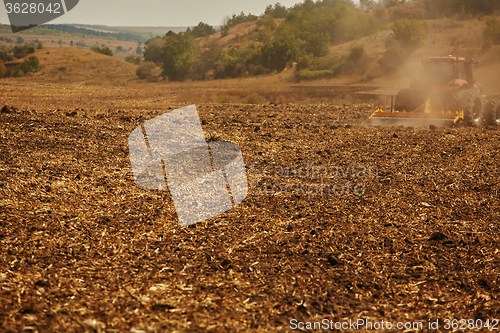 Image of Agricultural Landscape. Tractor working on the field.