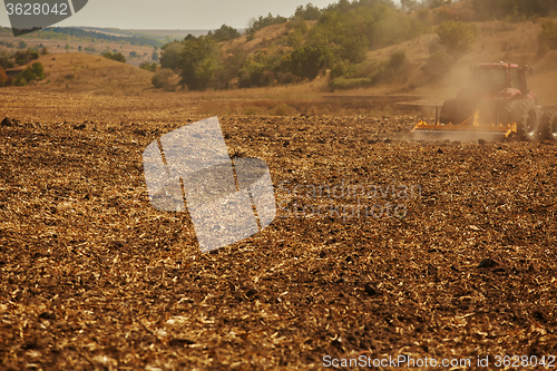 Image of Agricultural Landscape. Tractor working on the field.