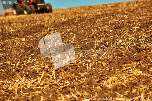 Image of Agricultural Landscape. Tractor working on the field.