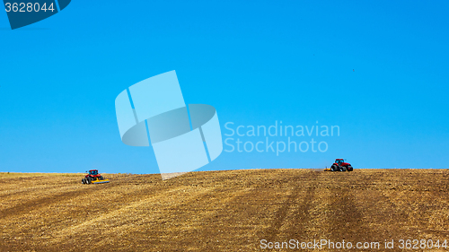 Image of Agricultural Landscape. Tractors working on the field.