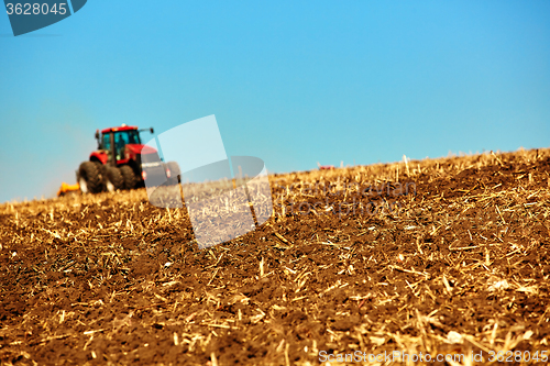 Image of Agricultural Landscape. Tractor working on the field.