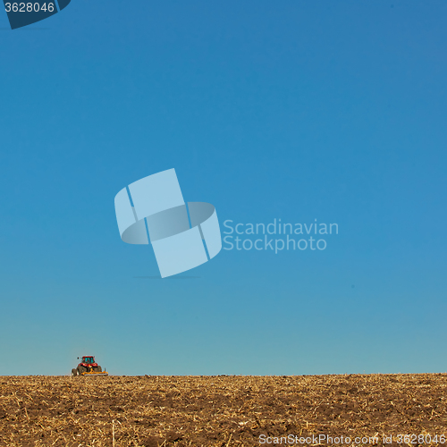 Image of Agricultural Landscape. Tractor working on the field.