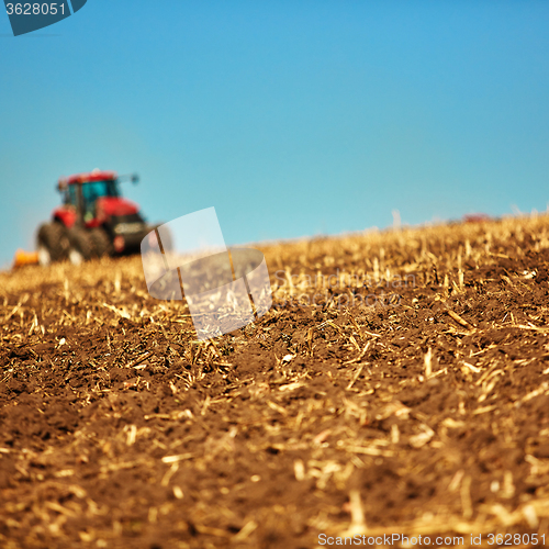Image of Agricultural Landscape. Tractor working on the field.
