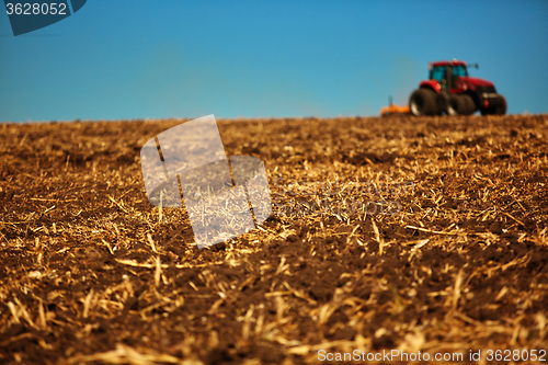 Image of Agricultural Landscape. Tractor working on the field.