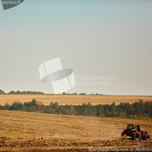 Image of Agricultural Landscape. Tractor working on the field.