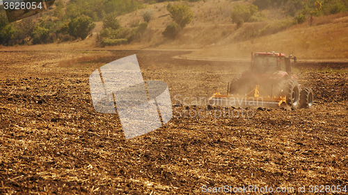 Image of Agricultural Landscape. Tractor working on the field.