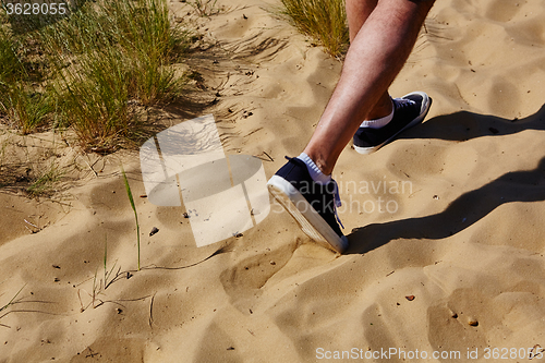Image of Close up fashion image of man walking alone 