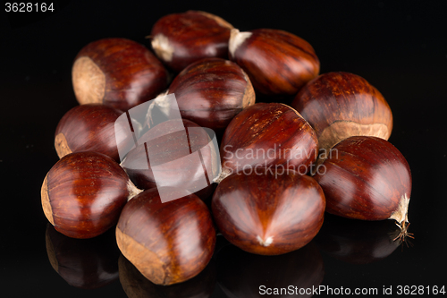 Image of Chestnuts on a black reflective background