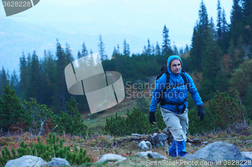 Image of advanture man with backpack hiking