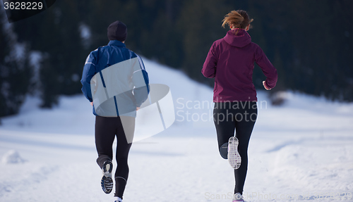 Image of couple jogging outside on snow