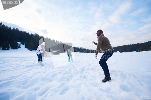 Image of happy family playing together in snow at winter