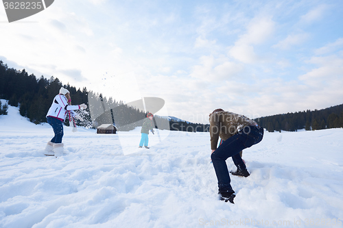 Image of happy family playing together in snow at winter