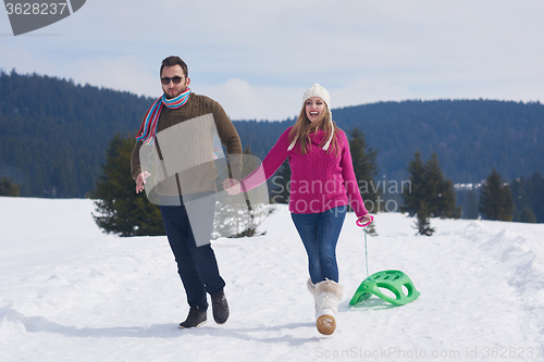 Image of happy young couple having fun on fresh show on winter vacation