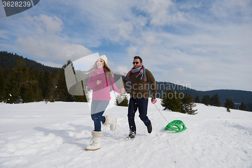 Image of happy young couple having fun on fresh show on winter vacation