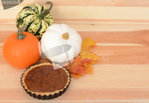 Image of Fall pumpkins and leaves with pumpkin pie