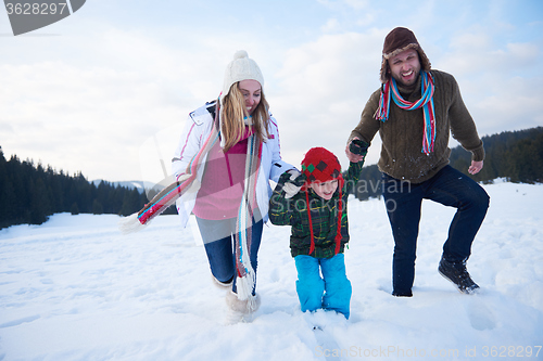 Image of happy family playing together in snow at winter