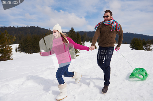 Image of happy young couple having fun on fresh show on winter vacation