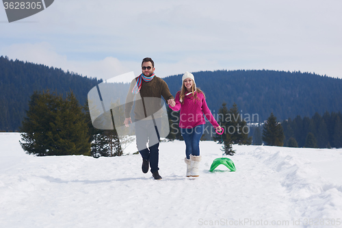 Image of happy young couple having fun on fresh show on winter vacation