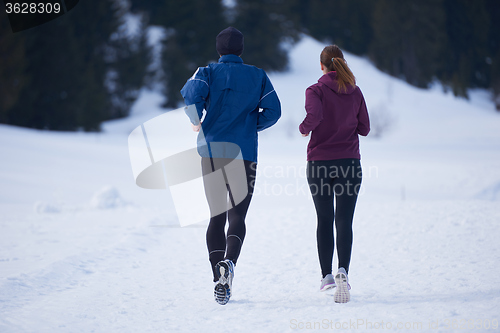 Image of couple jogging outside on snow