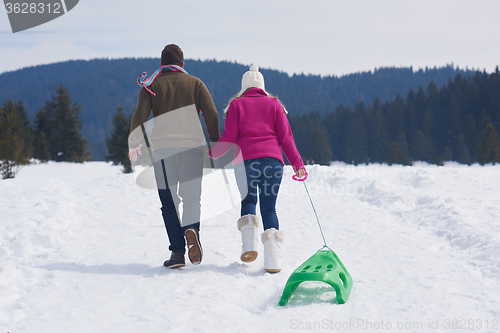 Image of happy young couple having fun on fresh show on winter vacation